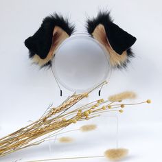 a cat ears and tail on top of a mirror