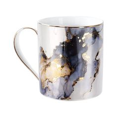 a white and gold coffee cup on a white background with golden foiling around the edges