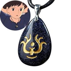 a necklace with an image of a boy in the background and a gold zodiac sign on it