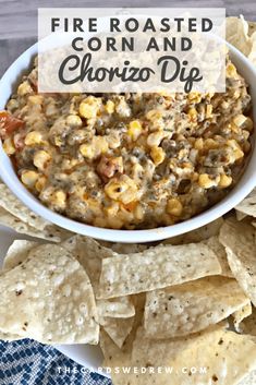 a white bowl filled with corn and chorizo dip surrounded by tortilla chips