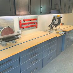 two workbenches with tools on top of them in a room filled with cabinets