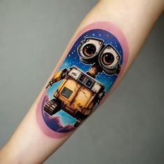 a person with a tattoo on their arm that has an image of a robot in space