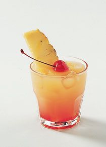 a pineapple drink with a cherry garnish on the rim