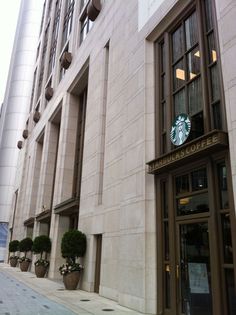 the starbucks sign is on the side of the building