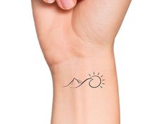 a woman's arm with a small tattoo on the left side of her wrist