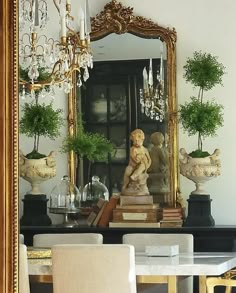 a dining room table with chairs and a mirror