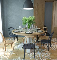 a dining room table with chairs, plates and vases on the centerpiece in front of it