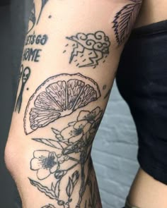 a woman's arm with tattoos on it that has flowers and lemons on it