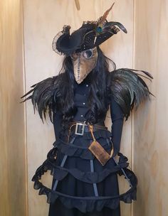 a costume made to look like a woman with feathers on her head and black dress