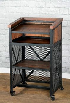 a wooden and metal side table on wheels