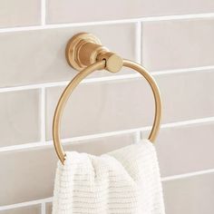 a gold towel ring hanging on the wall