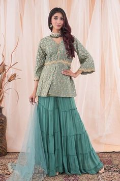 Aqua jade green peplum top with floral patterns, tasseled placket and placed pearl, cutdana, sequins and zari zardozi scalloped embroidery. Comes with tiered sharara and sequin spread dupatta. - Aza Fashions Green Peplum Festive Dress, Festive Green Peplum Dress, Designer Green Dress With Ruffles, Festive Green Peplum Sharara, Festive Peplum Sets With Ruffles, Green Bollywood Sharara With Ruffles, Green Palazzo Set With Unstitched Blouse For Reception, Elegant Green Tops For Eid, Green Ruffled Sharara For Wedding