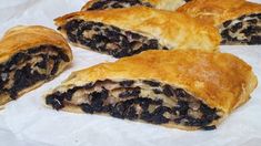 three pastries sitting on top of white paper