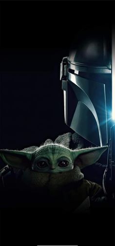 the child yoda from star wars is shown in front of a light saber and helmet