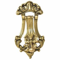 an ornate gold door handle on a white background