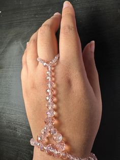 Hi! Welcome to my glass crystal wrist to ring bracelet!  Gift for yourself or a friend to match with any outfit! Perfect for every day wear!  The bracelet is made out of stretchy string that can be double layered for sturdiness.  The beads themselves are faceted Glass Beads that are wrapped around the wrist and up the top of the hand to the middle ring finger..  Sizes are small medium and large, respectively 7 inches,7.5 and 8 inch diameter.  Please message me for any questions I will respond im Adjustable Clear Bangle Jewelry, Handmade Clear Jewelry For Party, Adjustable Faceted Crystal Beads, Party Crystal Jewelry With Faceted Details, Faceted Crystal Jewelry For Parties, Adjustable Crystal Bracelets For Party, Spiritual Party Bracelets With Faceted Beads, Adjustable Crystal Bangle Bracelet For Party, Hand Wrapped Bracelet Jewelry For Party