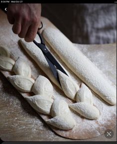 a person cutting up some food on top of a table