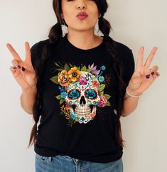 Dia de los muertos shirt,Sugar skull tshirt,Hispanic Heritage Month,Day of the dead,Mexican shirt,Latina shirt,Mexican floral skull https://etsy.me/349fSXd  PRODUCT DESCRIPTION WARNING: Please be aware these shirts are unisex model, for women suggested 1 (or 2) size down. Please check the colors and sizes on the images! .: Retail fit .: 100% Soft cotton (fibre content may vary for different colors) .: Light fabric (4.2 oz/yd² (142 g/m .: Tear away label .: Runs true to size Machine wash: warm (m Dia De Los Muertos Shirt Ideas, Mexican Shirts, Hispanic Heritage Month, Heritage Month, Floral Skull, Hispanic Heritage, Skull Tshirt, Day Of The Dead, Sugar Skull