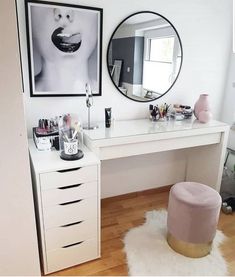 a white desk topped with a mirror and lots of makeup on top of wooden floors