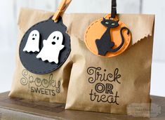 two paper bags with halloween tags on them