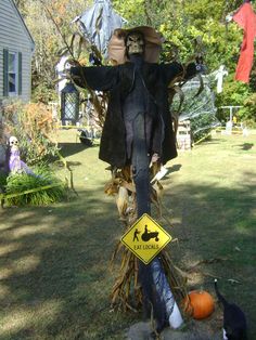 a scarecrow is standing in the yard