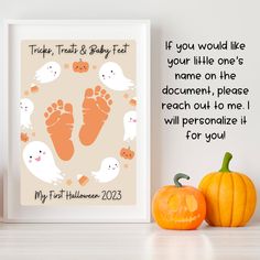 two pumpkins are sitting next to a poster with a baby's footprints on it