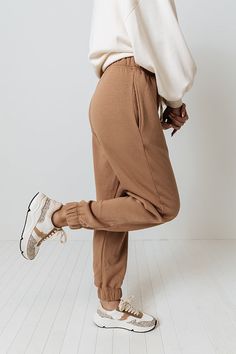 Spend your down time in comfort with these brown joggers featuring soft lightweight material, an elastic waistline with a tie closure, accent side pockets, and a slouched pants silhouette that tapers into fitted ankle-length hemlines! Measurements S : Front Rise 11.5", Hip 34", Inseam 27.5", Length 38.5", Waist 26-30". M : Front Rise 11.5", Hip 36", Inseam 28", Length 39", Waist 28-32". L : Front Rise 11.5", Hip 38", Inseam 28", Length 39", Waist 30-34". XL : Front Rise 12", Hip 40", Inseam 28.5", Length 39.5", Waist 32-36". Pants Silhouette, Brown Joggers, Swimsuit Sale, Dress Cuts, Women Clothing Boutique, Dresses With Leggings, Cropped Tank Top, Hip Length, Online Womens Clothing