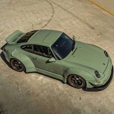 a green car parked on top of a parking lot