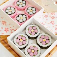 there are four different types of sushi in the box and one has pink flowers on it