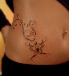 a woman with a butterfly tattoo on her stomach