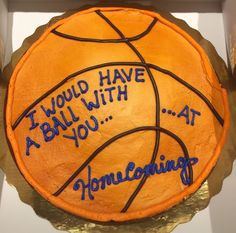 a cake that has been decorated to look like a basketball ball with writing on it