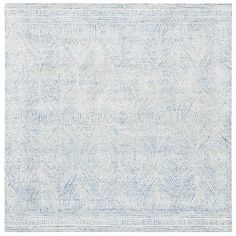 a blue and white rug with an intricate design on the bottom, in front of a white background