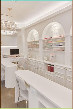 an office with white desks and shelves filled with bottles