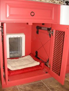 a red cabinet with a dog bed in it