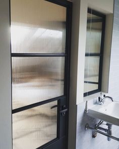 a bathroom with a sink and large glass doors