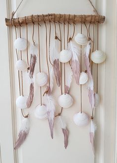 a wall hanging made out of shells and feathers