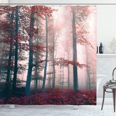 a bathroom with a shower curtain that has red leaves on the ground in front of it