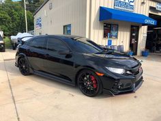 a black car parked in front of a building