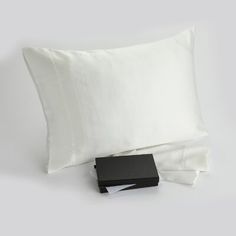 a white pillow and some black sheets