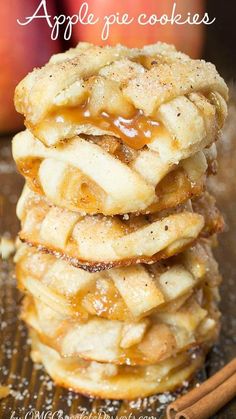 apple pie cookies stacked on top of each other in front of an apple and cinnamon stick