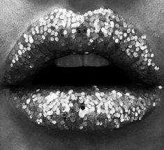 a woman's lips covered in glitters with her mouth open to the side