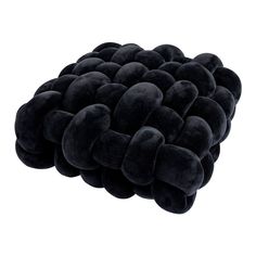 a large black cushion with many hearts on the bottom and one heart at the top