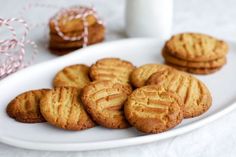 some cookies are on a white plate with candy canes