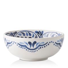 a white bowl with blue designs on the rim and bottom, sitting in front of a white background