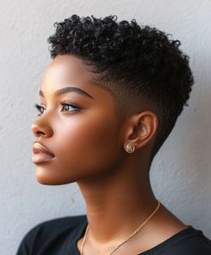 A fade that tapers down to the skin, providing a striking and crisp appearance. Great for a fresh and contemporary style. Taper Fade Black Women, Womens Tapered Natural Haircut, Black Women Fades Haircuts, Short Hair Black Women Natural, Taper Fade Women, Fade Haircut Women Natural Hair, Twa Hairstyles 4c Hair Tapered With Designs, Black Women Short Haircut Fade Designs, Short Hair Style For Black Women Natural Shaved Sides