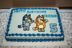 a birthday cake with an image of two cartoon characters on the front and number five on the back