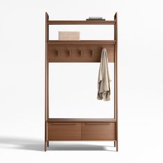 a coat rack with two coats hanging from it's sides and three drawers underneath