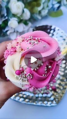 a cupcake decorated with pink and white frosting