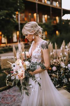 a woman in a wedding dress holding a bouquet