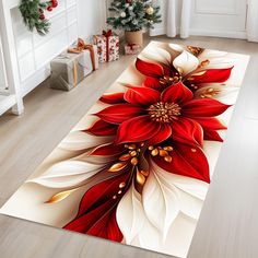 a red and white flower rug on the floor in front of a christmas tree with presents